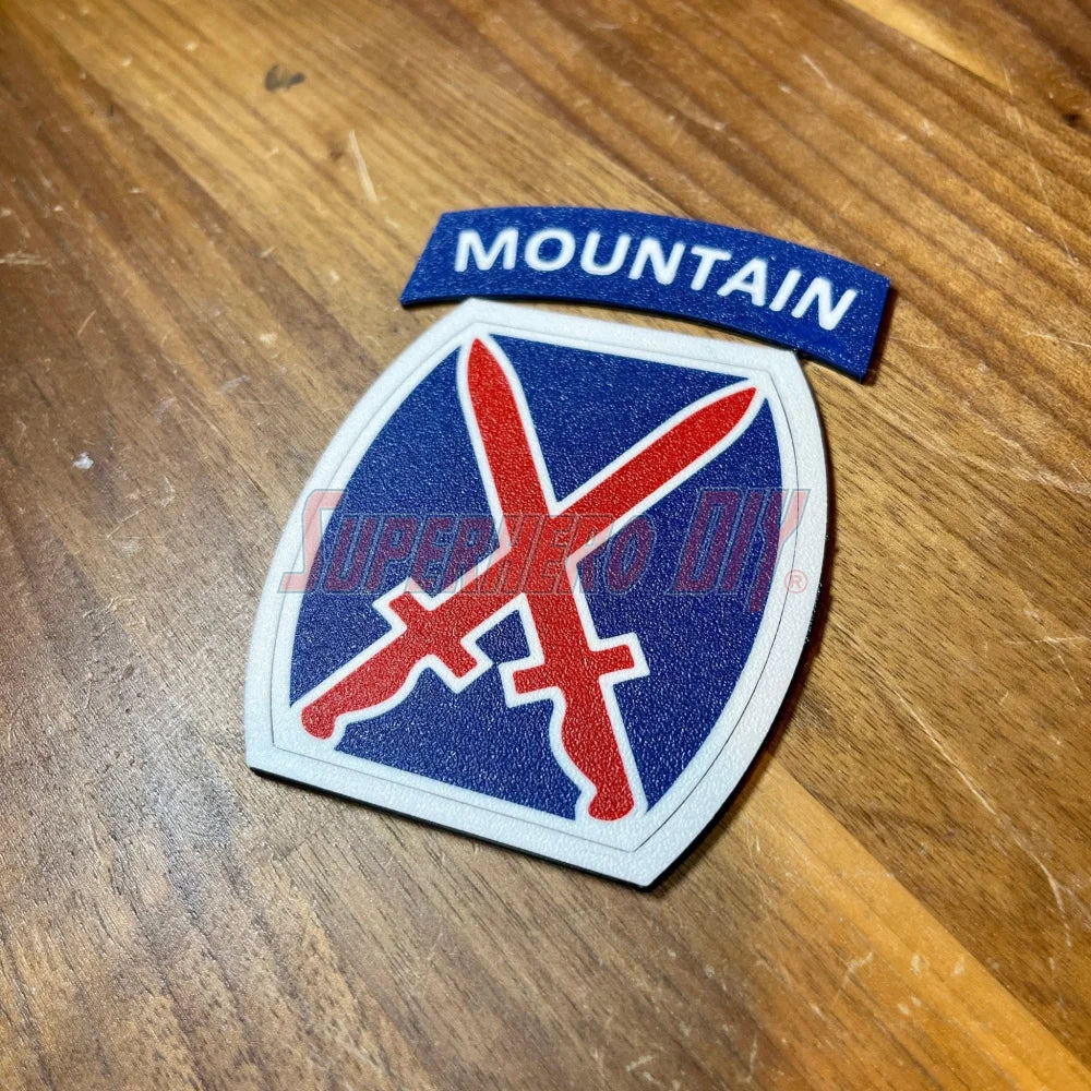 3D-printed 10th Mountain Division insignia patch on wooden surface