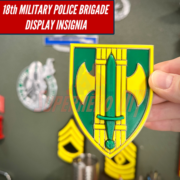 Hand holding 18th Military Police Brigade Display Insignia for wall mount or shadowbox.