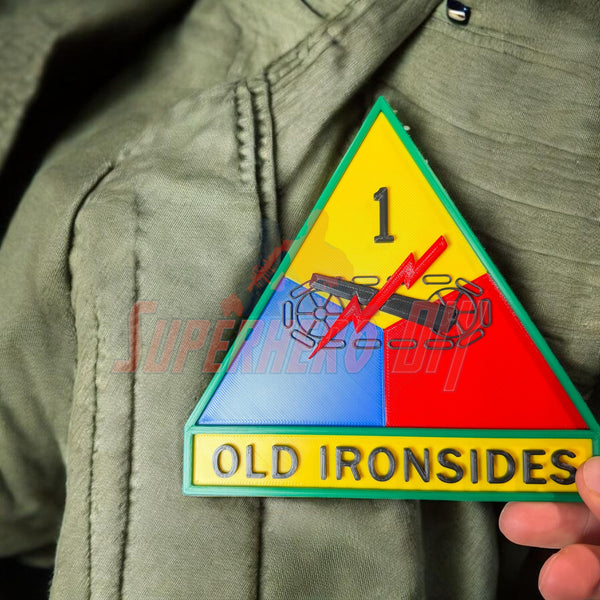 1st Armored Division display insignia featuring Old Ironsides patch on a military uniform.