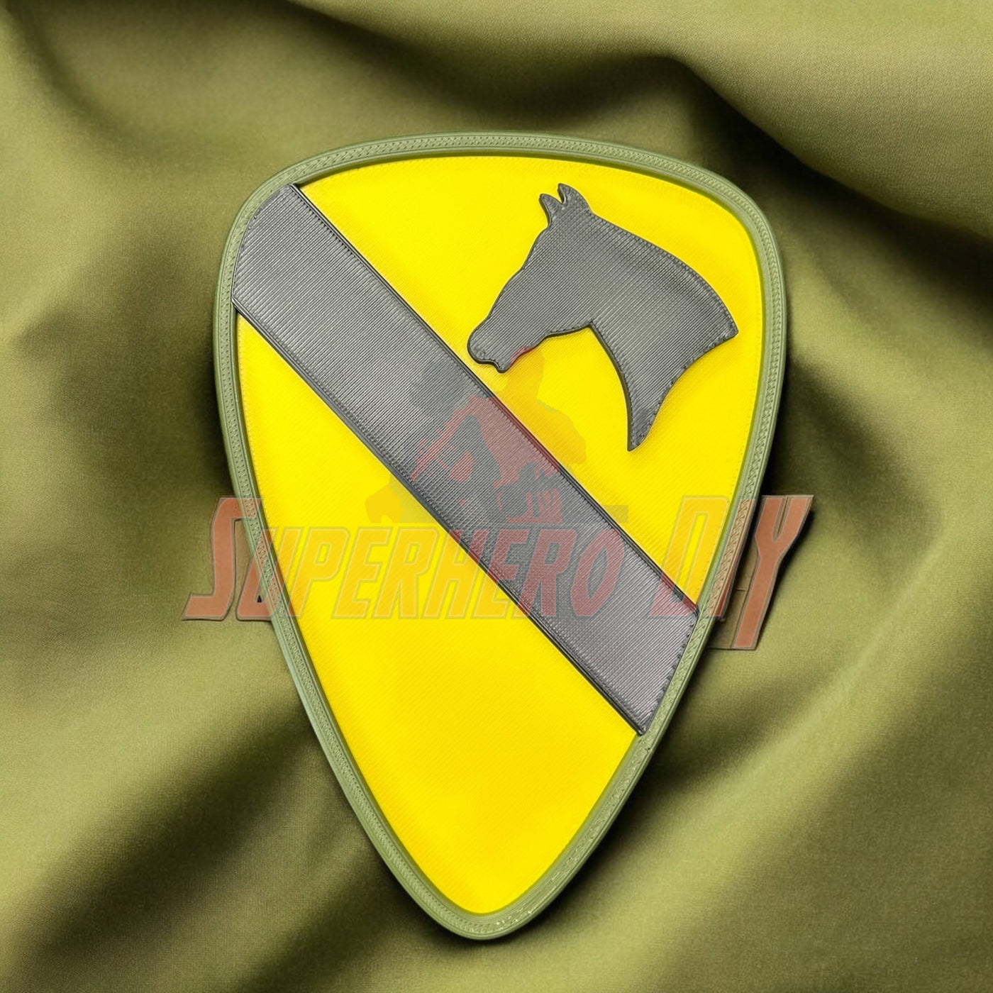 1st Cavalry Division Display Insignia on green fabric background, ideal for military decor in various settings.