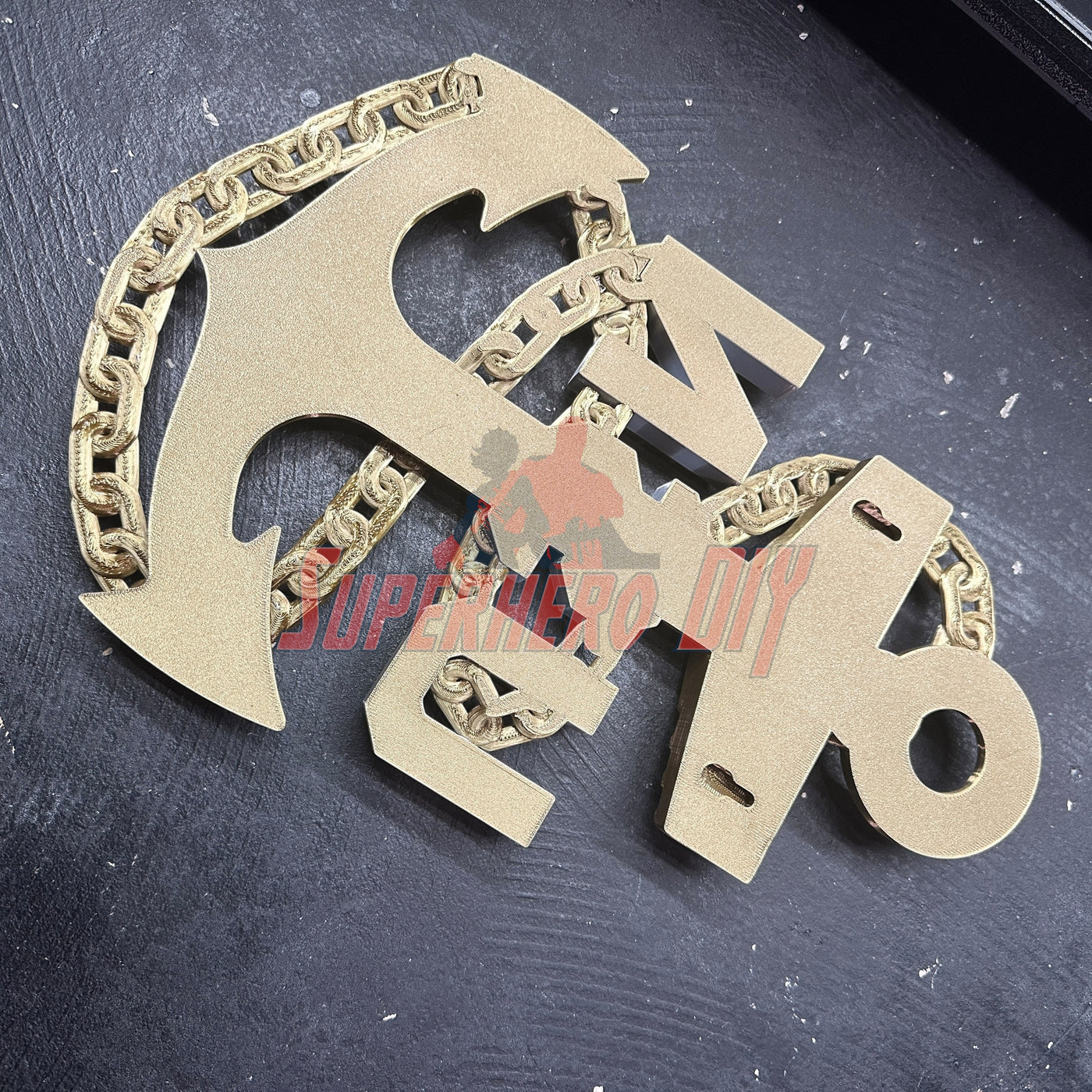 Navy enlisted rate insignia badge in gold-tone metal with anchor and chain design on black background. - SuperheroDIY