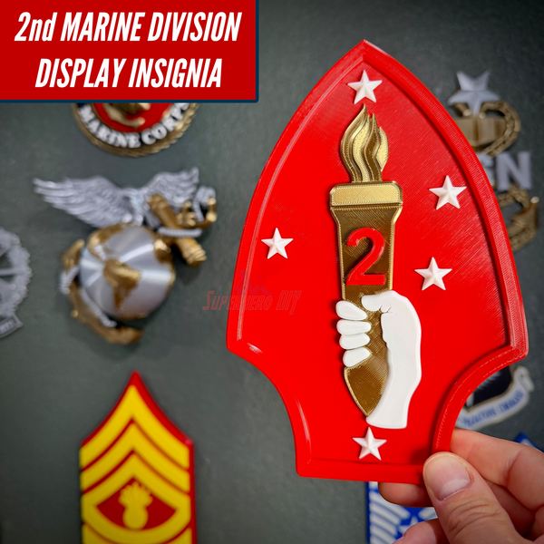 2nd Marine Division display insignia showcasing layered relief design with a torch and stars