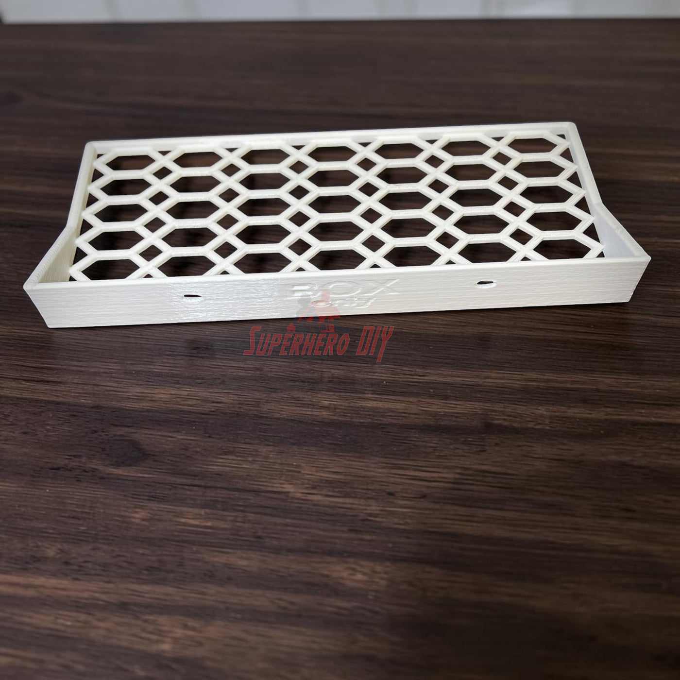 Floating shelf for Funko Pop 2-pack on a wooden surface, showcasing open hex lattice design.