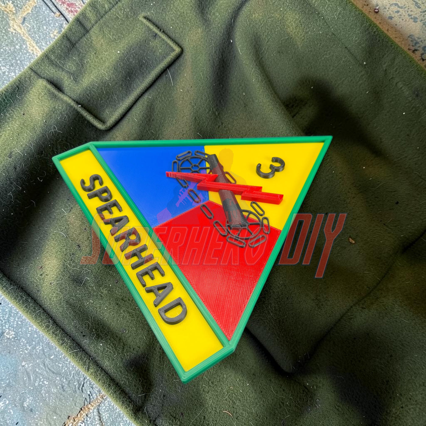 3rd Armored Division display insignia featuring the Spearhead emblem in vibrant colors on a dark background.