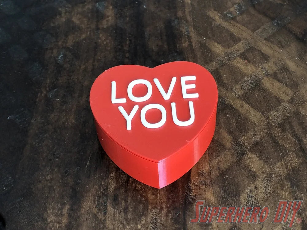 3D-PRINTABLE STL FILE | Candy Heart Gift Box | DIGITAL FILE ONLY - Red heart-shaped gift box with white "LOVE YOU" text on top, smooth glossy finish. - SuperheroDIY