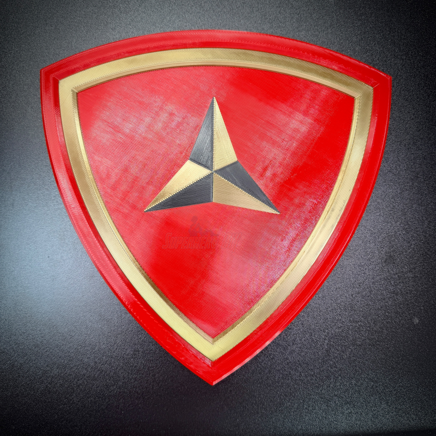 3rd Marine Division Display Insignia in red shield with gold border and three-pointed caltrap design.