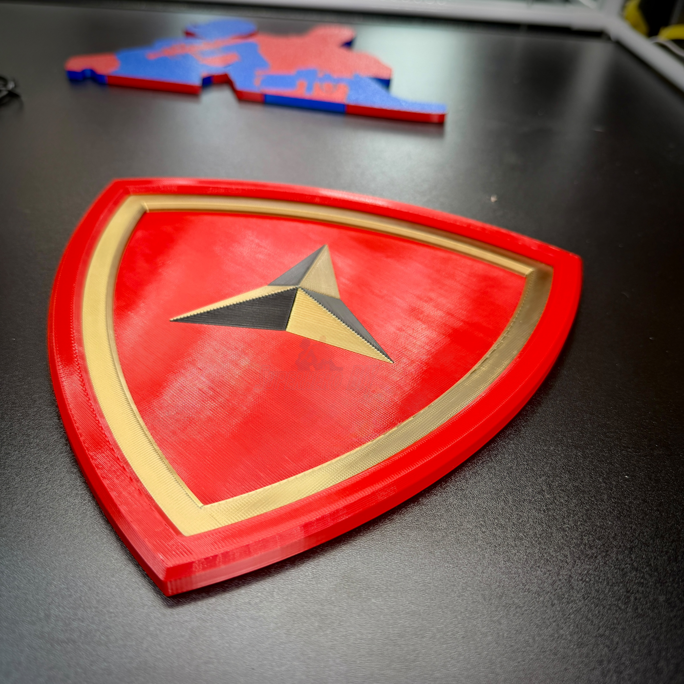 3rd Marine Division insignia in layered relief with scarlet shield and gold border, showcasing Fighting Third emblem.