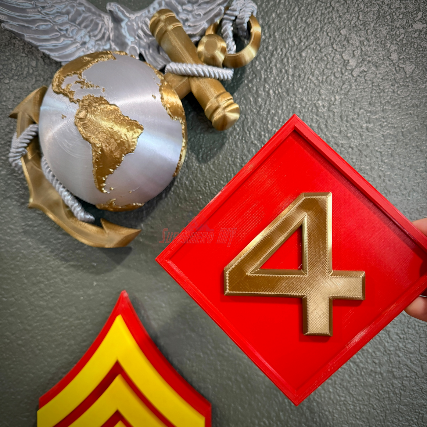 4th Marine Division display insignia with gold numeral four on a red background, showcasing the Fighting Fourth theme.