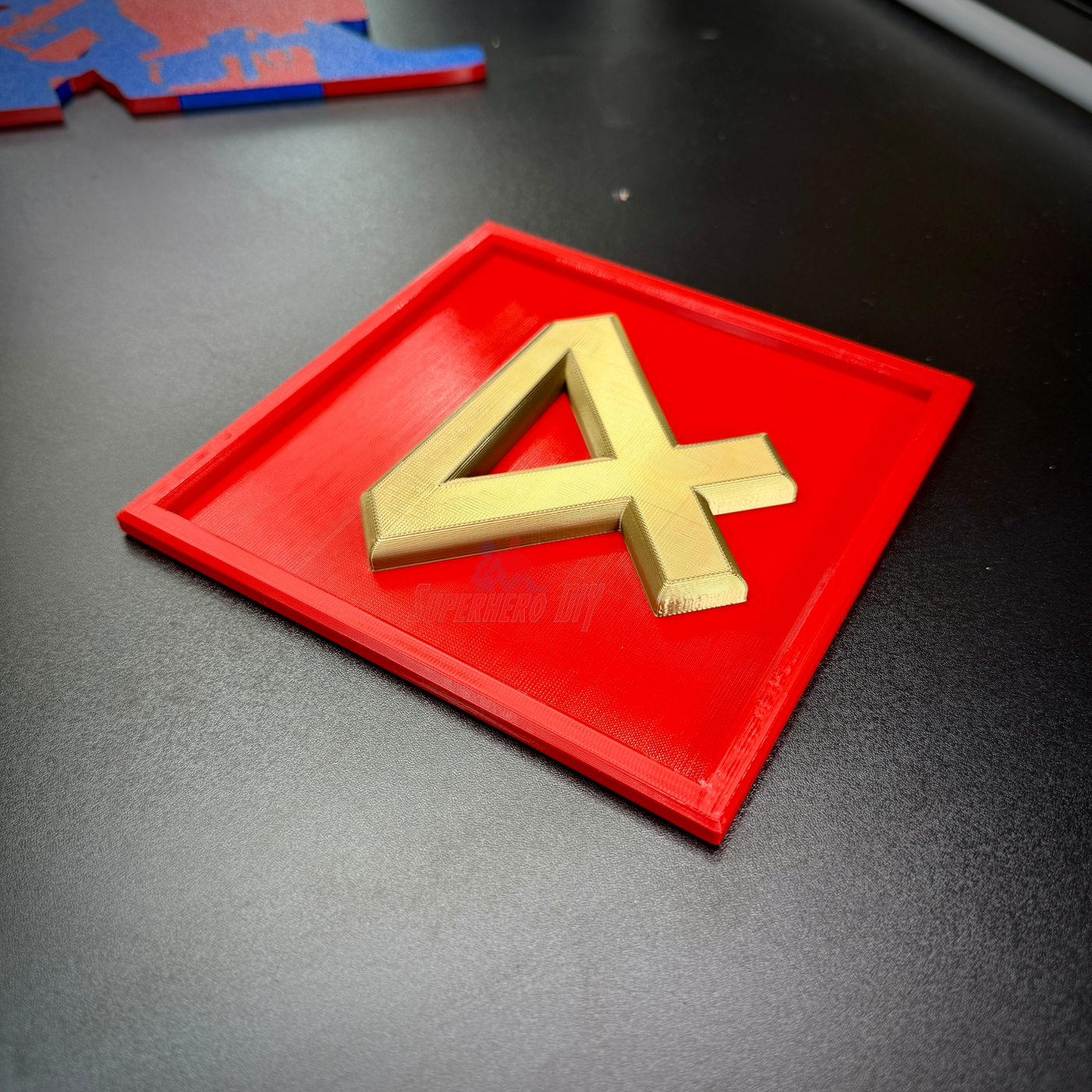 4th Marine Division insignia in layered relief with gold numeral four on red background for display.
