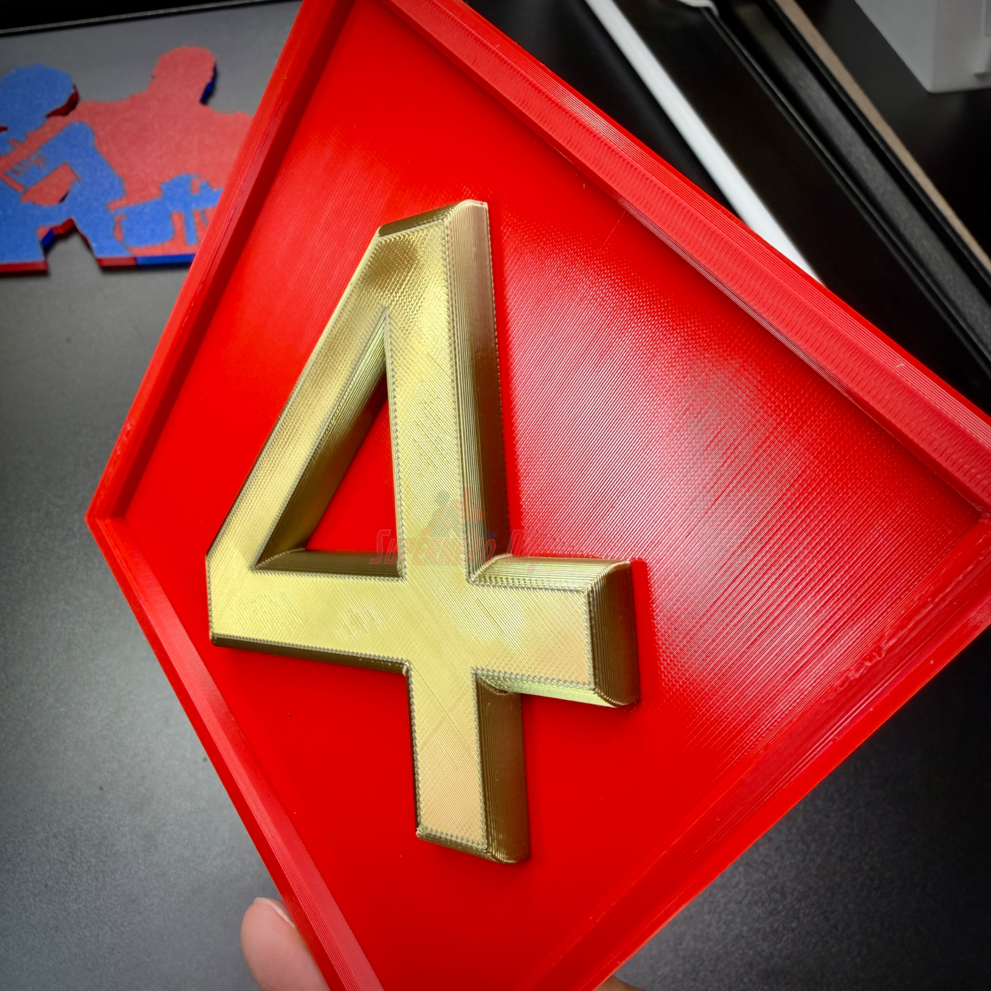 4th Marine Division insignia display with gold numeral 4 on a red background, ideal for military wall display.