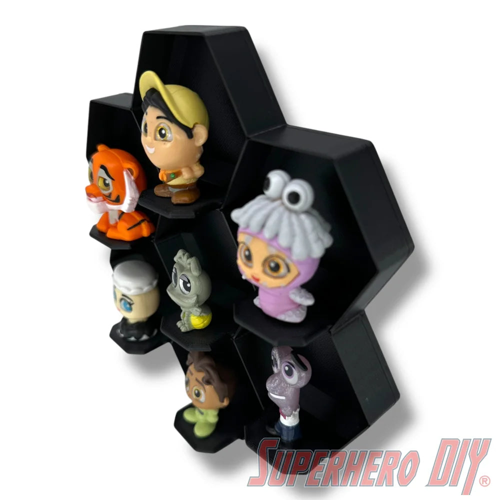 Wall-mounted honeycomb shelf for Disney Doorables, holds 7 figures with foot pegs for stable and organized display