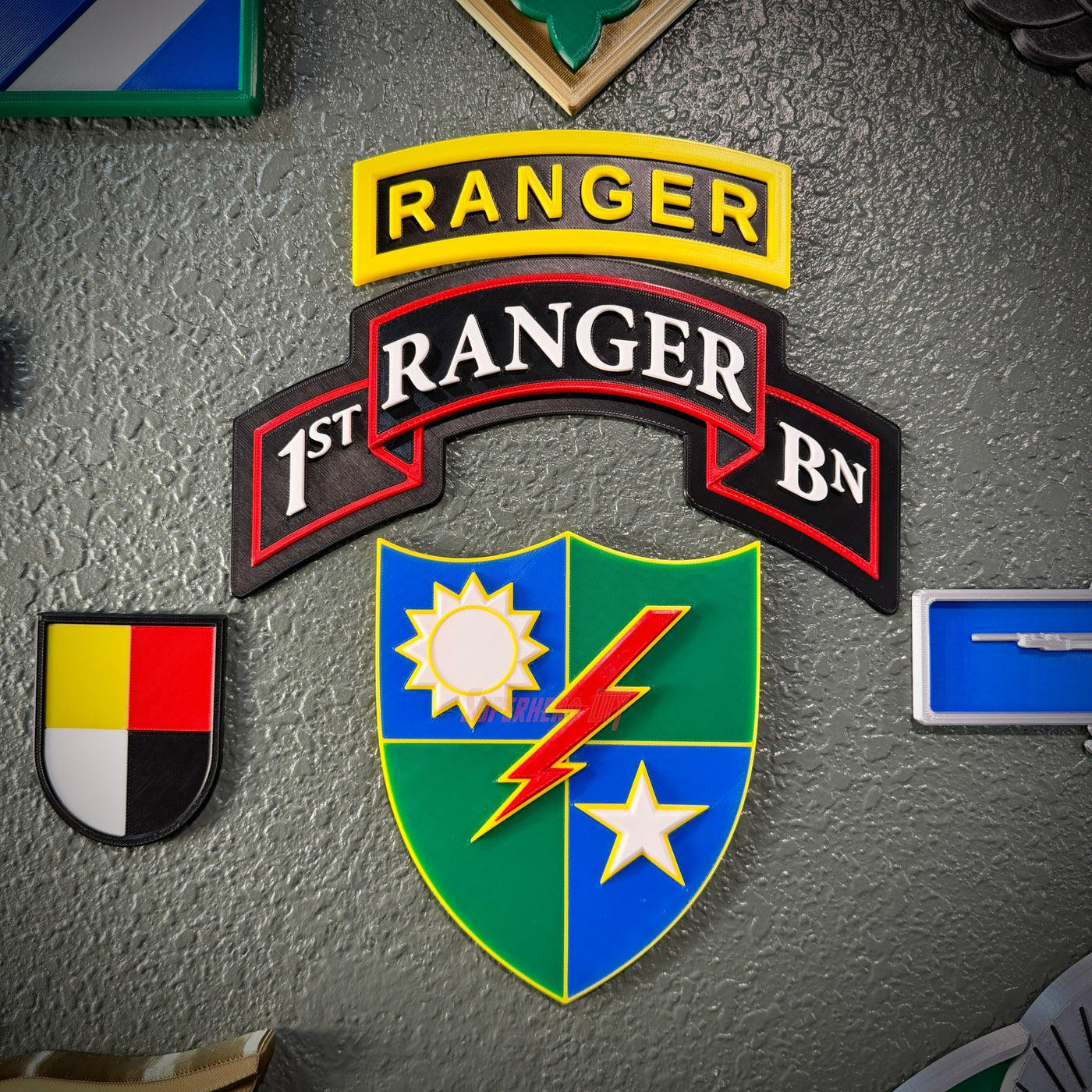 75th Ranger Regiment display insignia featuring patches and emblems for 1st Ranger Battalion.