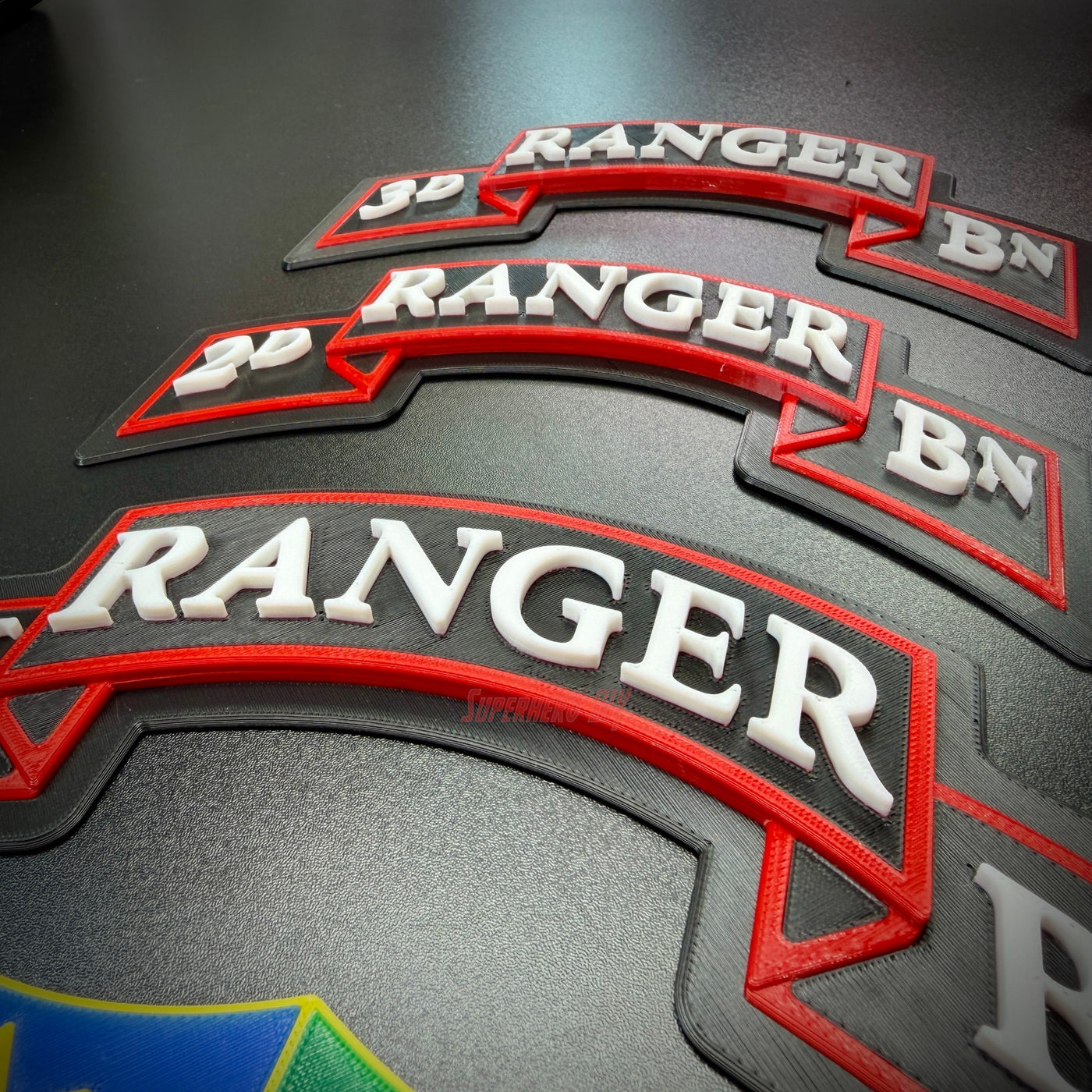 75th Ranger Regiment display insignia in multiple sizes showcasing detailed lettering and bold colors.