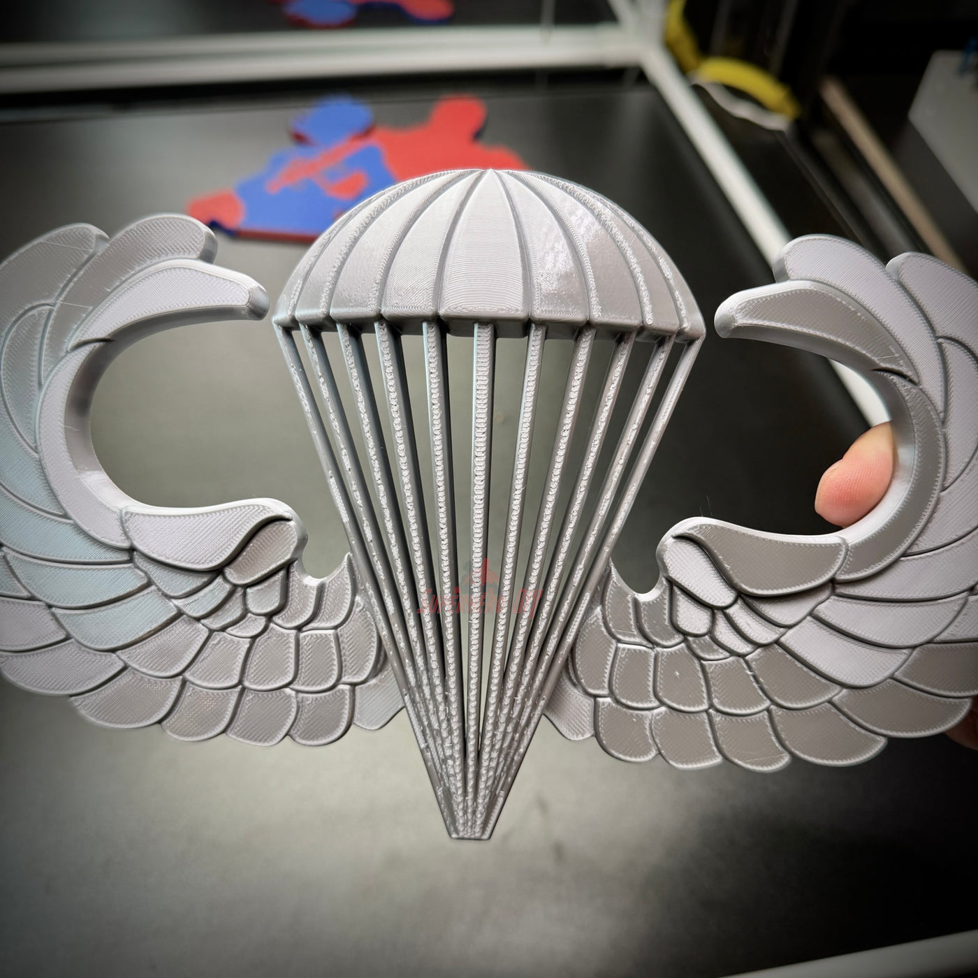 Airborne jump wings badge with detailed parachute and wings design, symbolizing parachutist achievement.