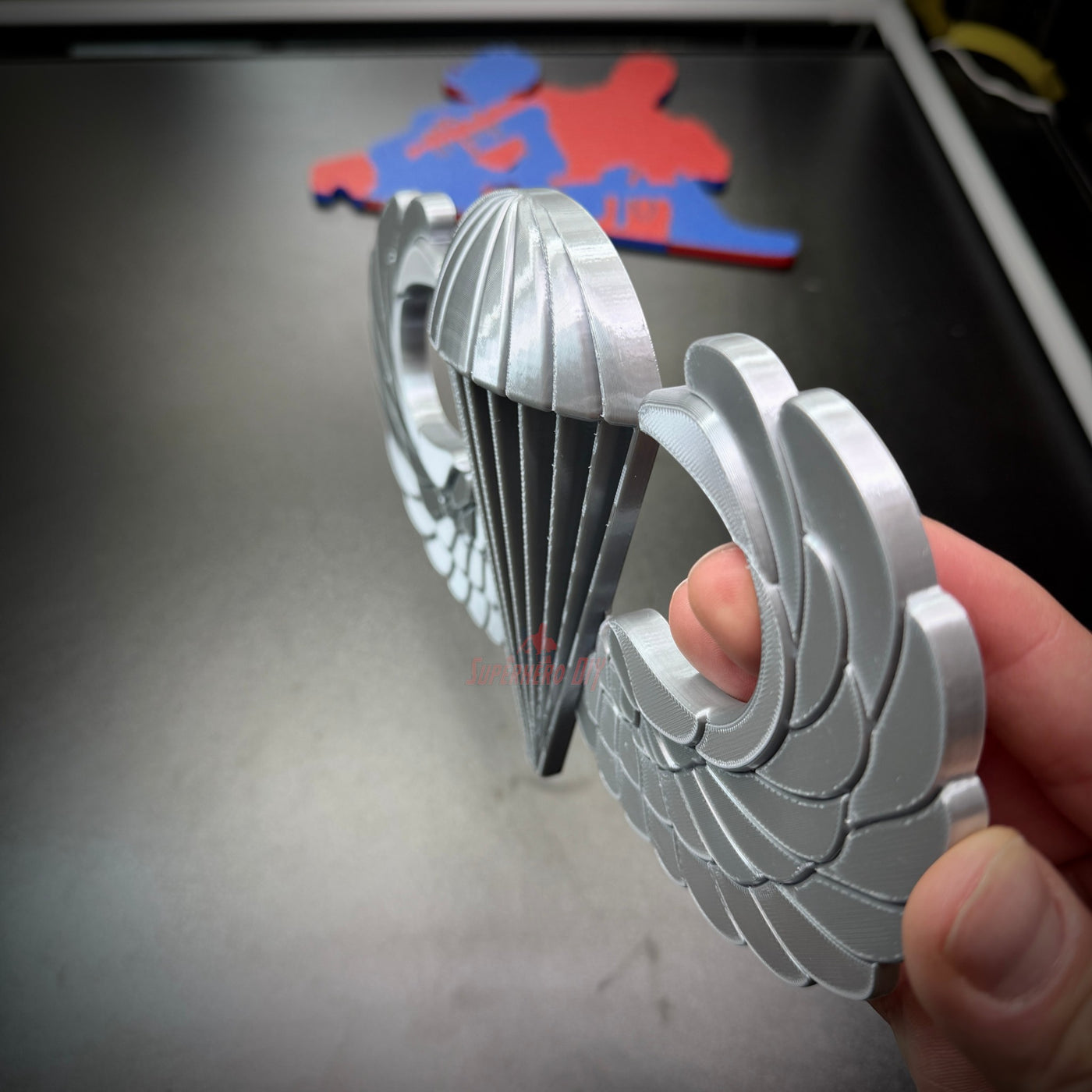 Airborne jump wings badge replica held in hand, showcasing fine details and design excellence.