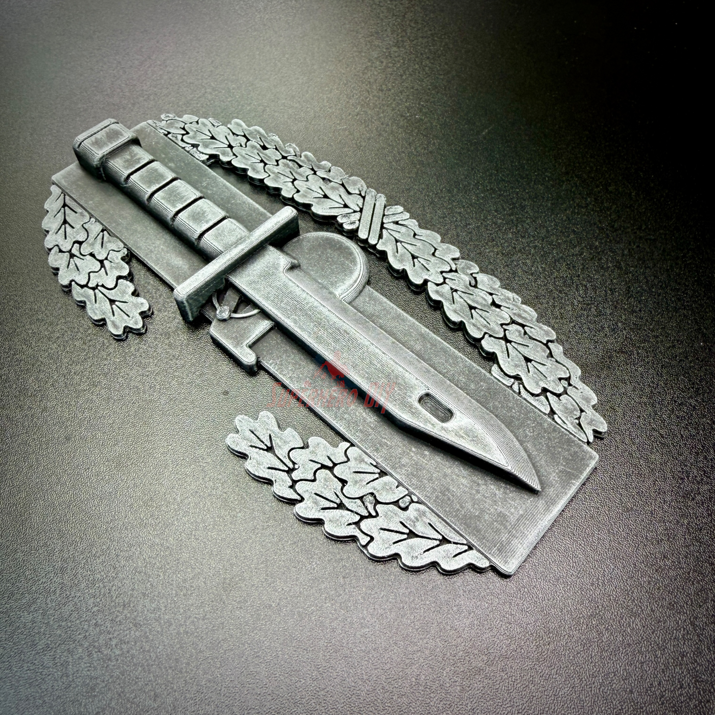 Combat Action Badge display insignia with pewter finish and knife design, ideal for wall or desk display.