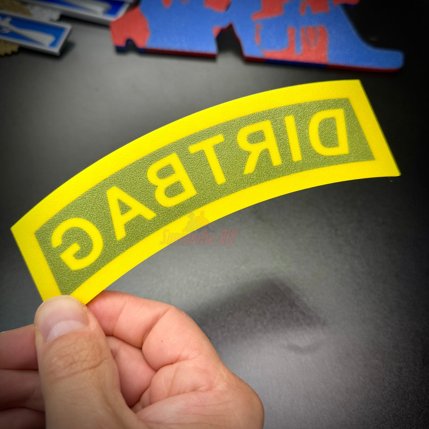 DIRTBAG tab displayed in hand, a gag gift for soldiers and battle buddies in black and yellow colors.