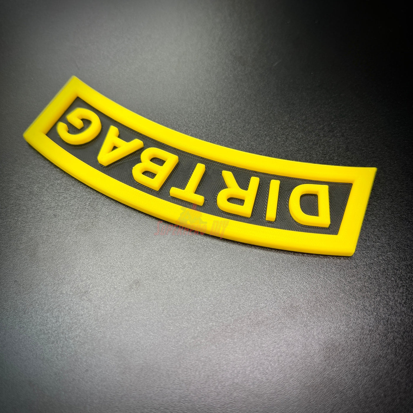 DIRTBAG tab in black and yellow, a humorous gag gift for military friends and battle buddies.