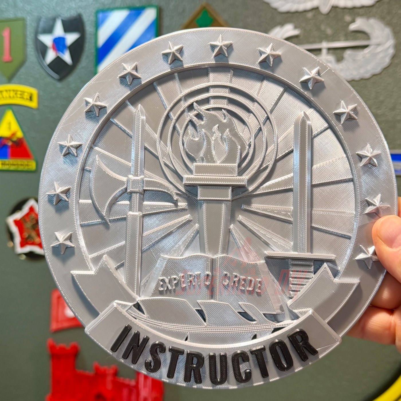 Army Instructor Badge display showing a gray circular insignia with the word 'INSTRUCTOR' and detailed imagery.