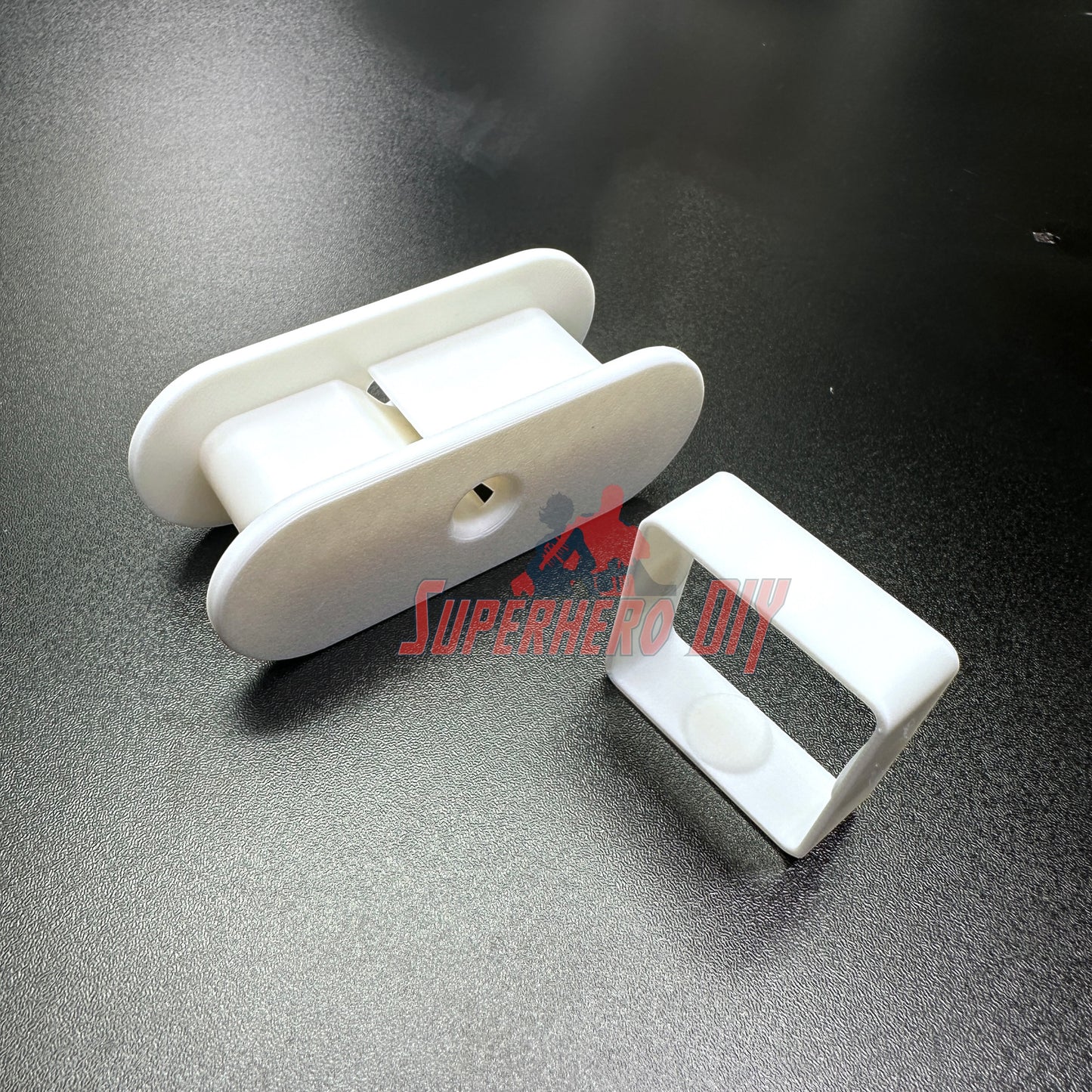 Fabric Tape Measure Holder | Snap-On Sewing Tape Storage for 60" or 145" Tailor’s Tapes | Plastic Sewing Tool for Quilters & DIY on a dark surface.