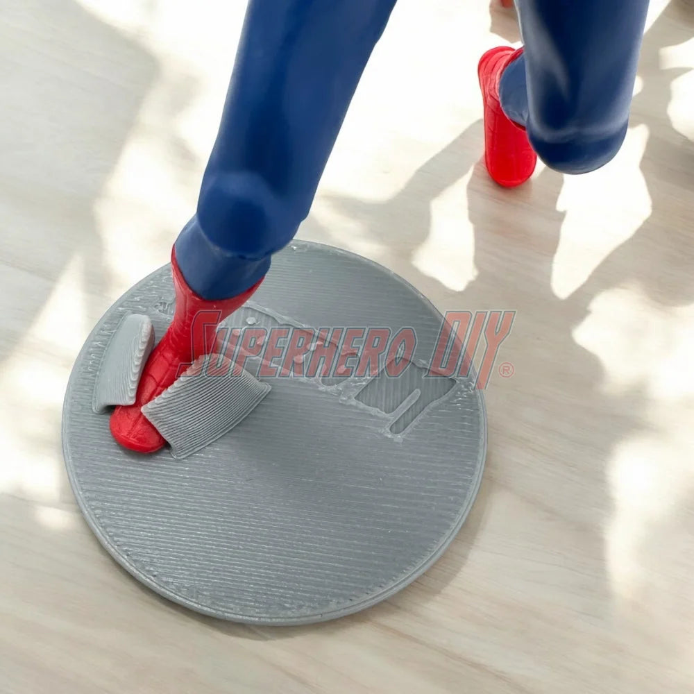 Foot Stands for 3.75-in to 4-in Action Figures in use with a superhero figure on wooden floor.