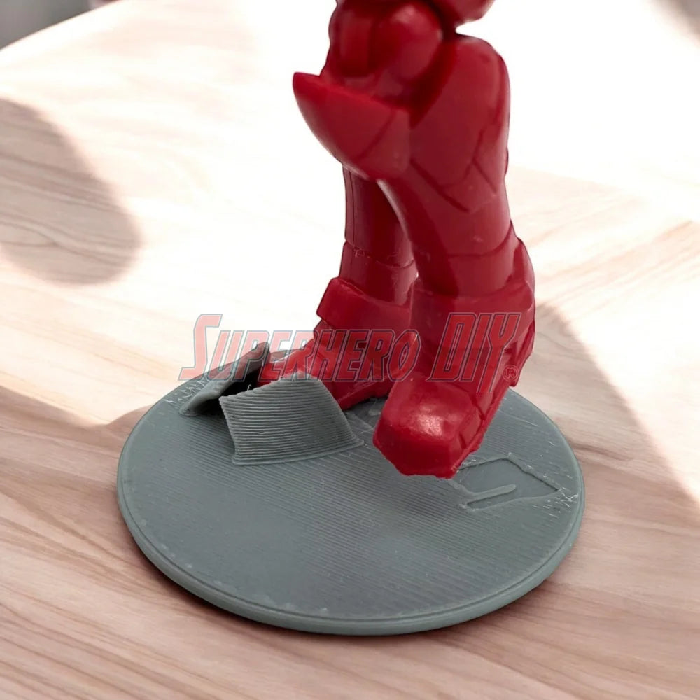 Foot Stands for 3.75-in to 4-in Action Figures holding red action figure on 1:18 scale display stand.