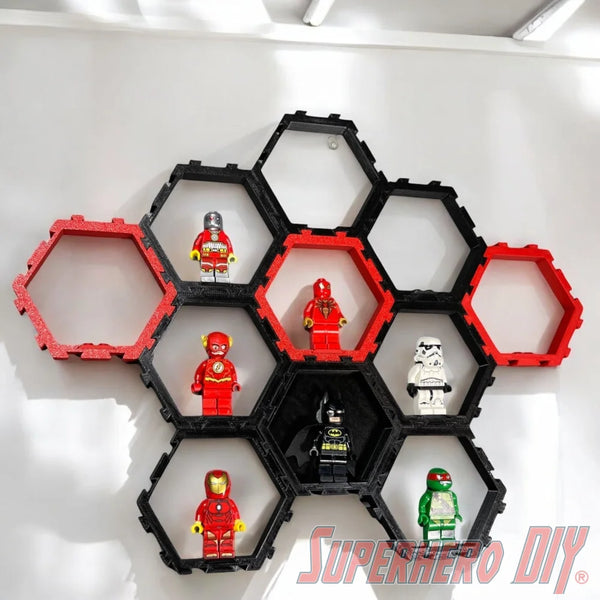 Hexagon LEGO minifigure display cells in black and red, mounted on a white wall with LEGO minifigures inside. - SuperheroDIY