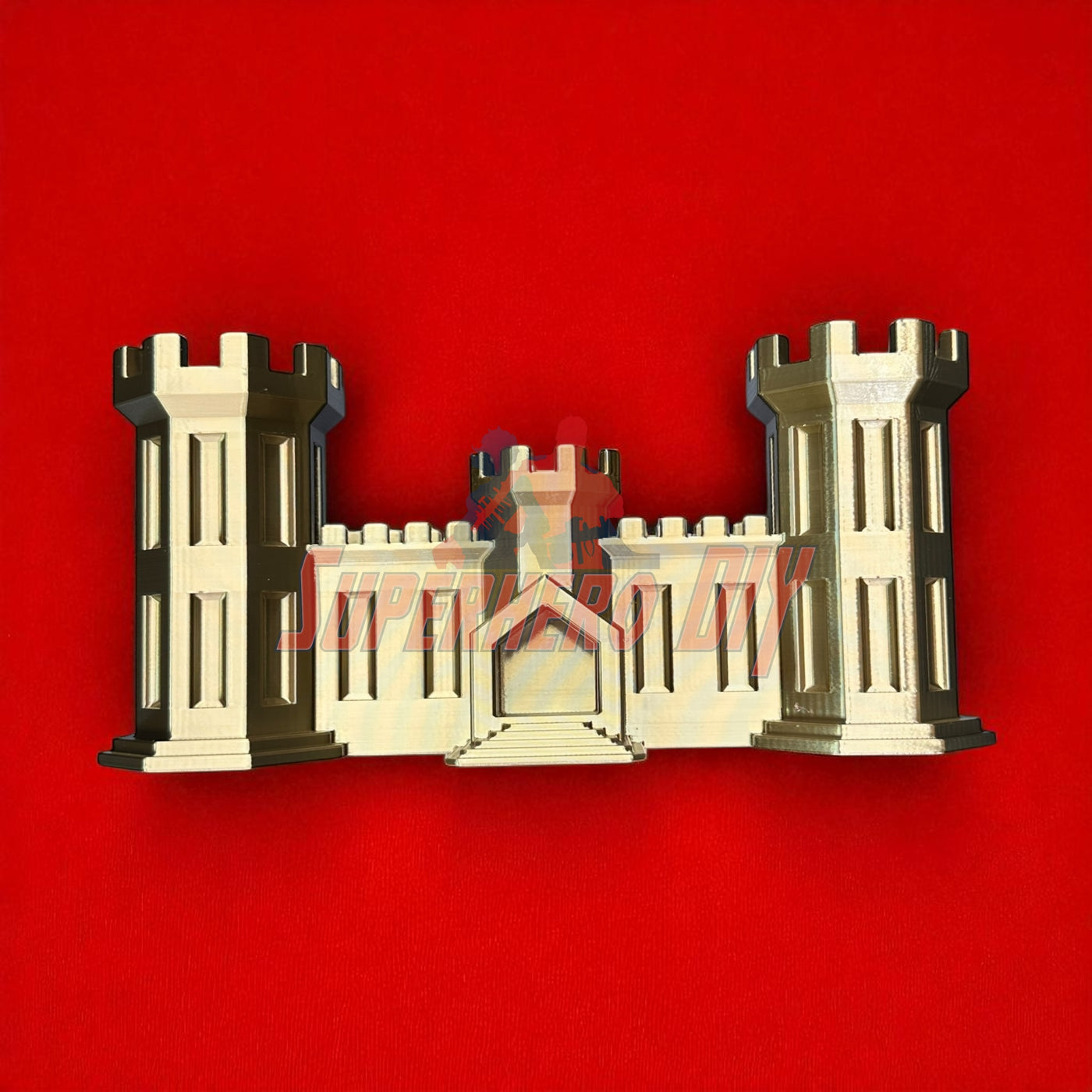 3D-printed model of the Army Engineer Castle symbolizing the U.S. Army Corps of Engineers, set on a red background.