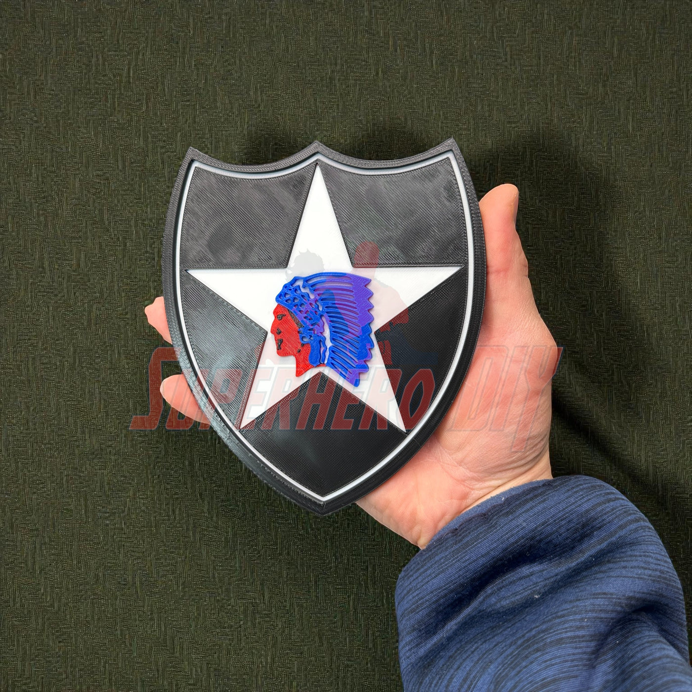 Hand holding a 2nd Infantry Division display insignia patch for military wall display