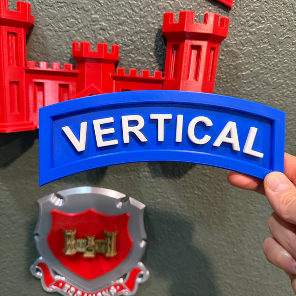 3D vertical construction engineer tab displayed with blue and white lettering 'VERTICAL' on a wall.