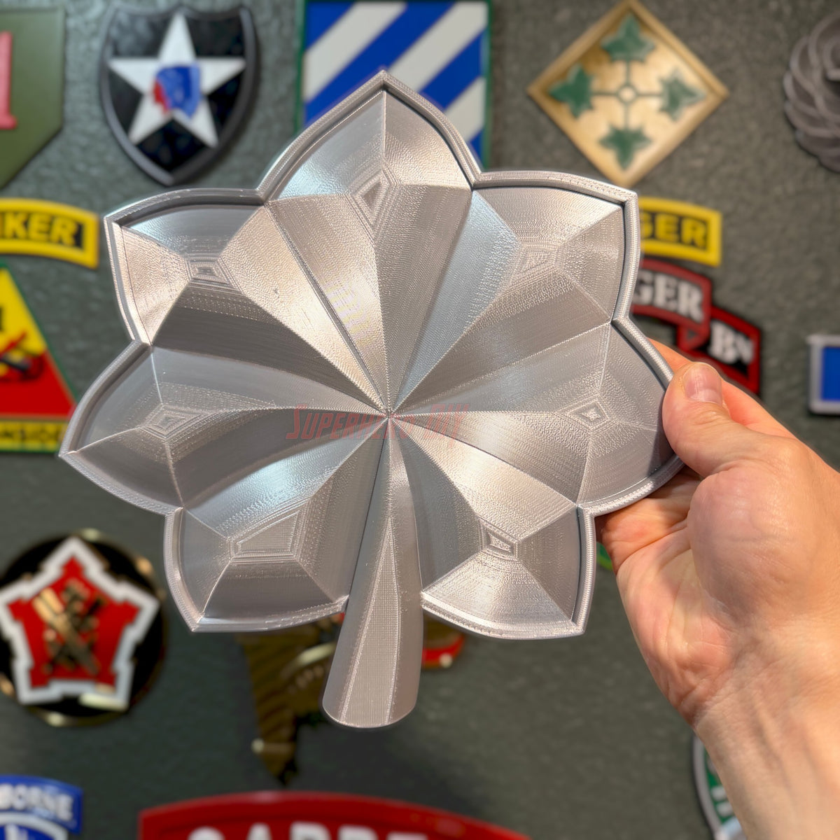 Lieutenant Colonel O-5 Commander rank insignia replica displayed in hand, showcasing detailed design and glossy finish