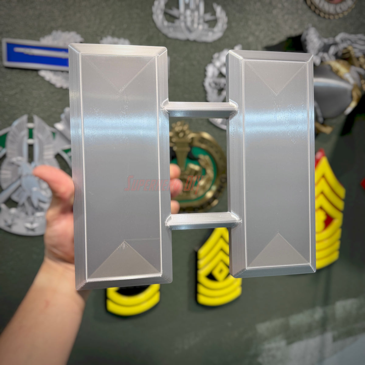 Captain O-3 Lieutenant rank insignia replica displayed in hand, showcasing glossy finish and detail
