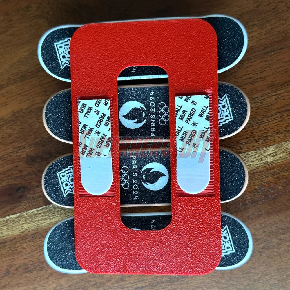 Magnetic Tech Deck wall mount displaying fingerboards with Paris 2024 theme, showcasing artwork and mini skateboard arrangement.