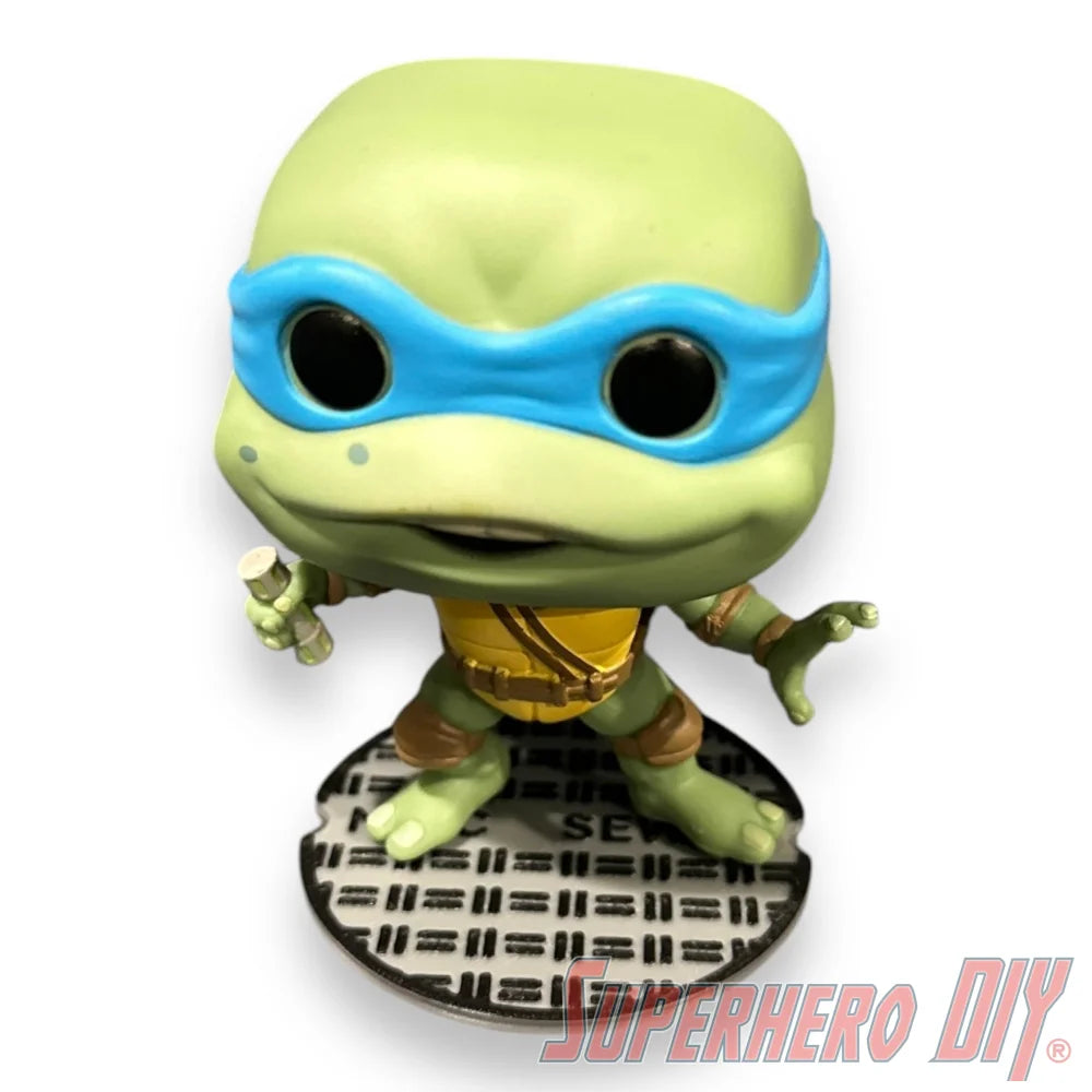 Floating shelf designed to display TMNT action figures and collectibles, styled like a sewer manhole cover for themed wall display