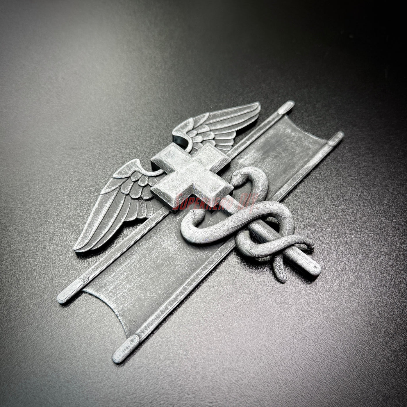 Army medical badge display featuring wings and caduceus symbol on a dark background.