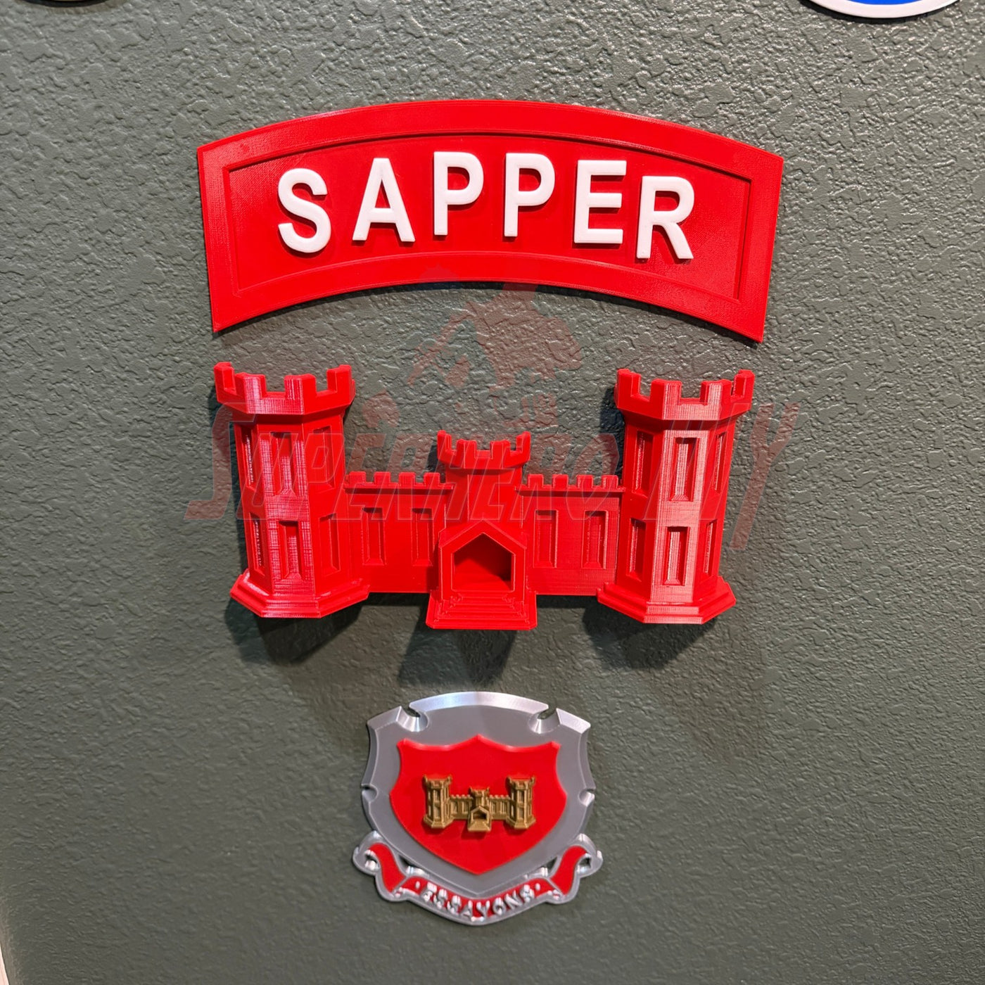 3D sapper tab display piece with red castle design and text, showcasing achievement for combat engineers.