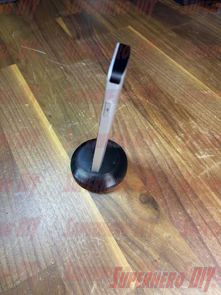 Apple TV Remote Stand displayed on wooden surface, showcasing 3D-printed design for holding Siri Remote vertically.