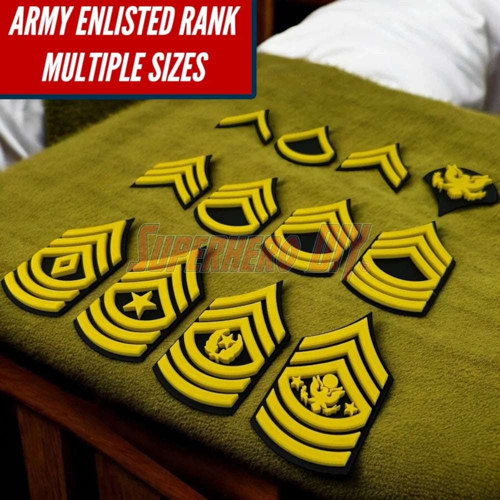 A collection of 3D-printed Army enlisted rank insignia in multiple sizes displayed on a surface.