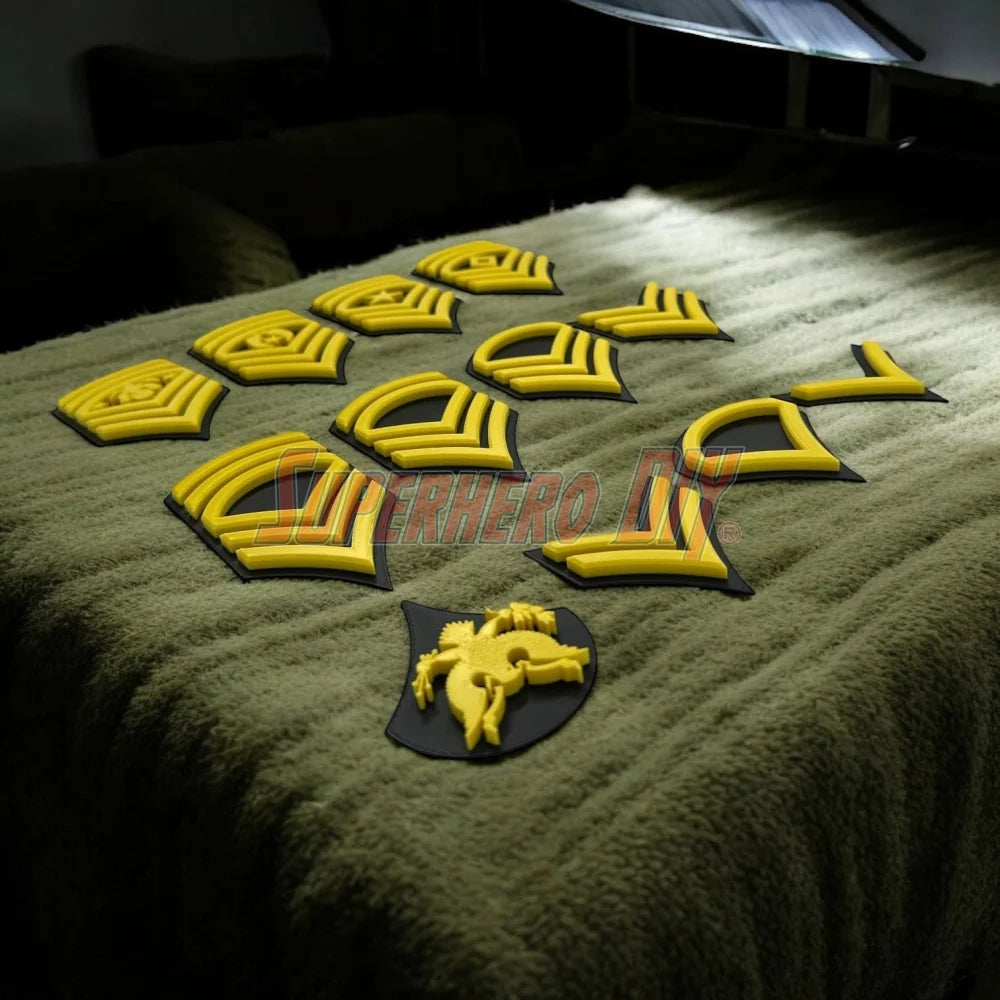 Army enlisted rank insignia displayed in yellow, showcasing various ranks for military tribute or decoration.