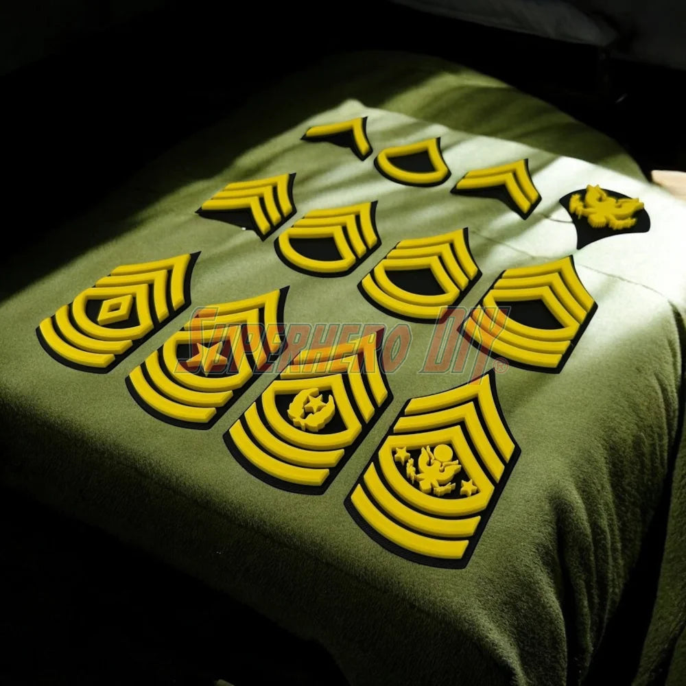 Army enlisted rank insignia displayed on a green surface, showcasing various ranks from Private to Sergeant Major.