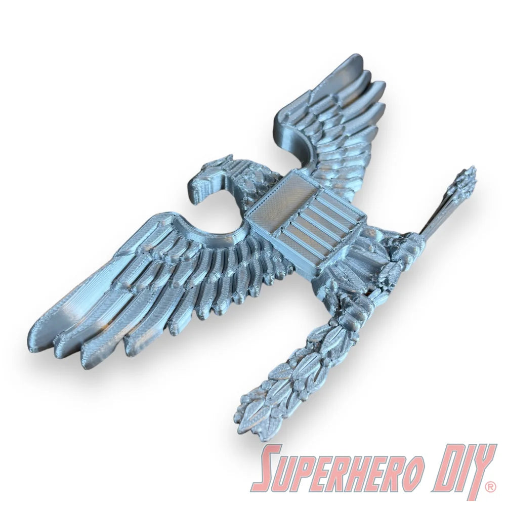 Silver US Military eagle officer rank insignia with detailed feathers and shield on chest. - SuperheroDIY