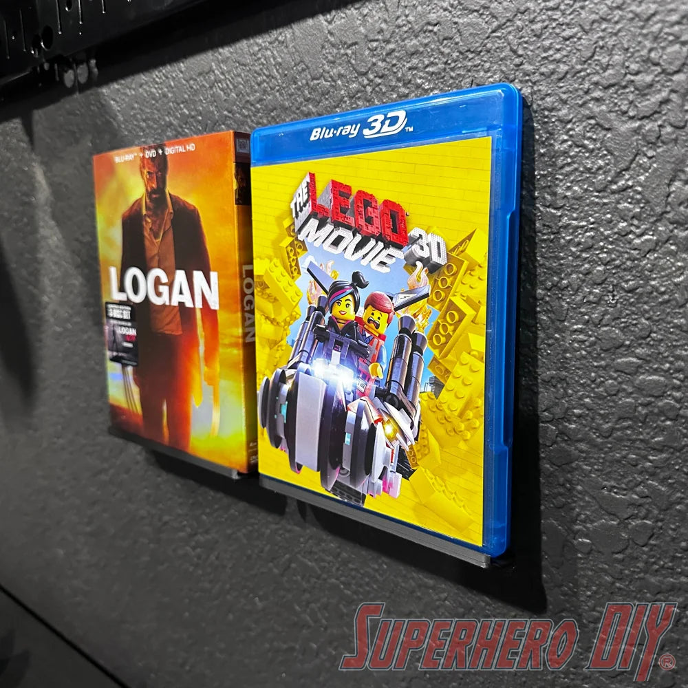 Floating shelf for movies or video games with Blu-ray display, featuring "Logan" and "The LEGO Movie" cases.