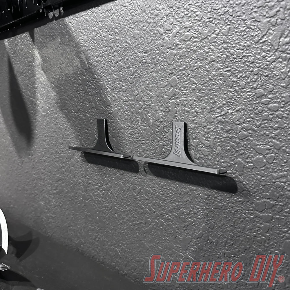 Floating shelf for movies or video games installed on wall with Command strip, ideal for Blu-rays and games display.