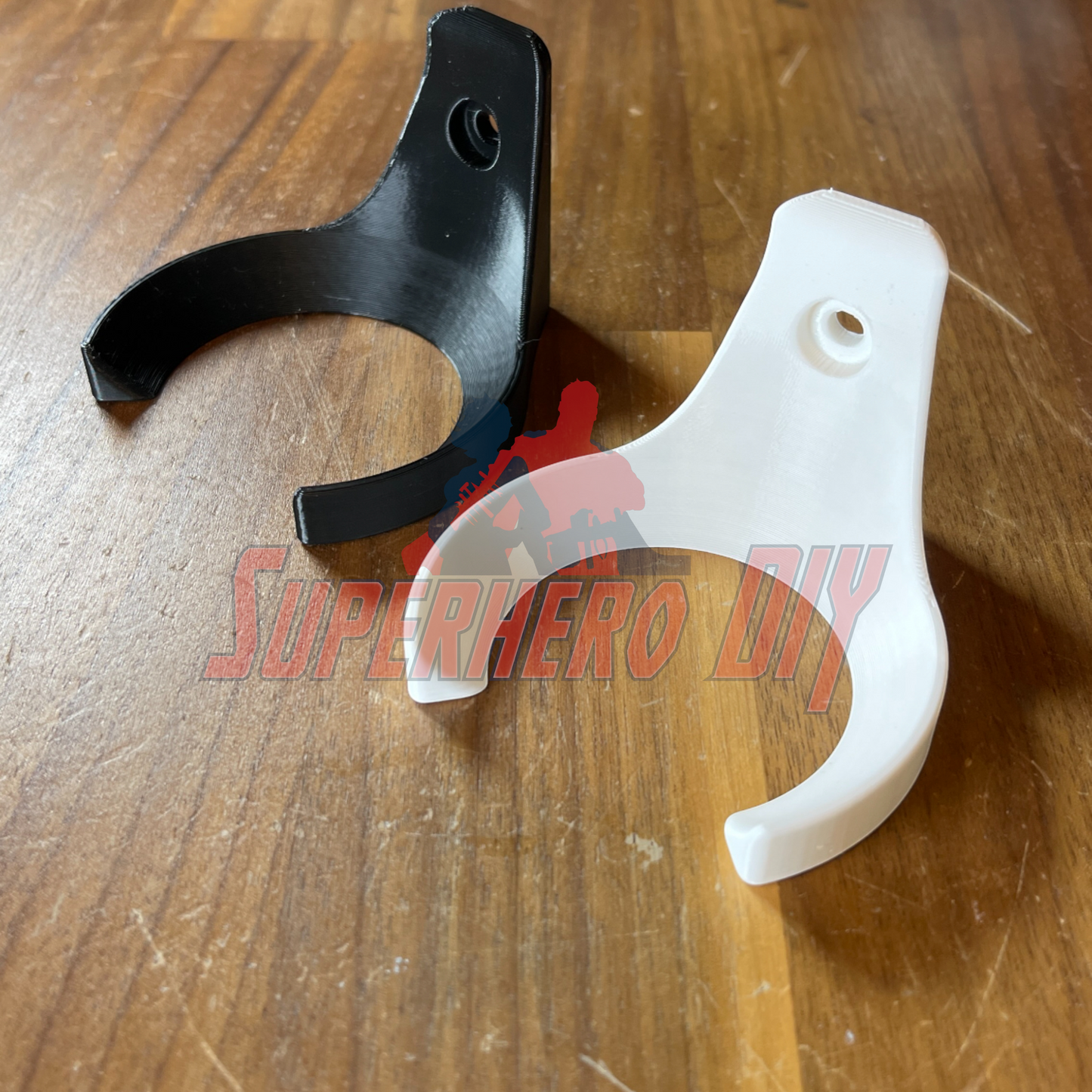 3D-printed Baseball Holder Wall Mount | Floating Shelf for Baseball Display; black and white holders on wooden surface.