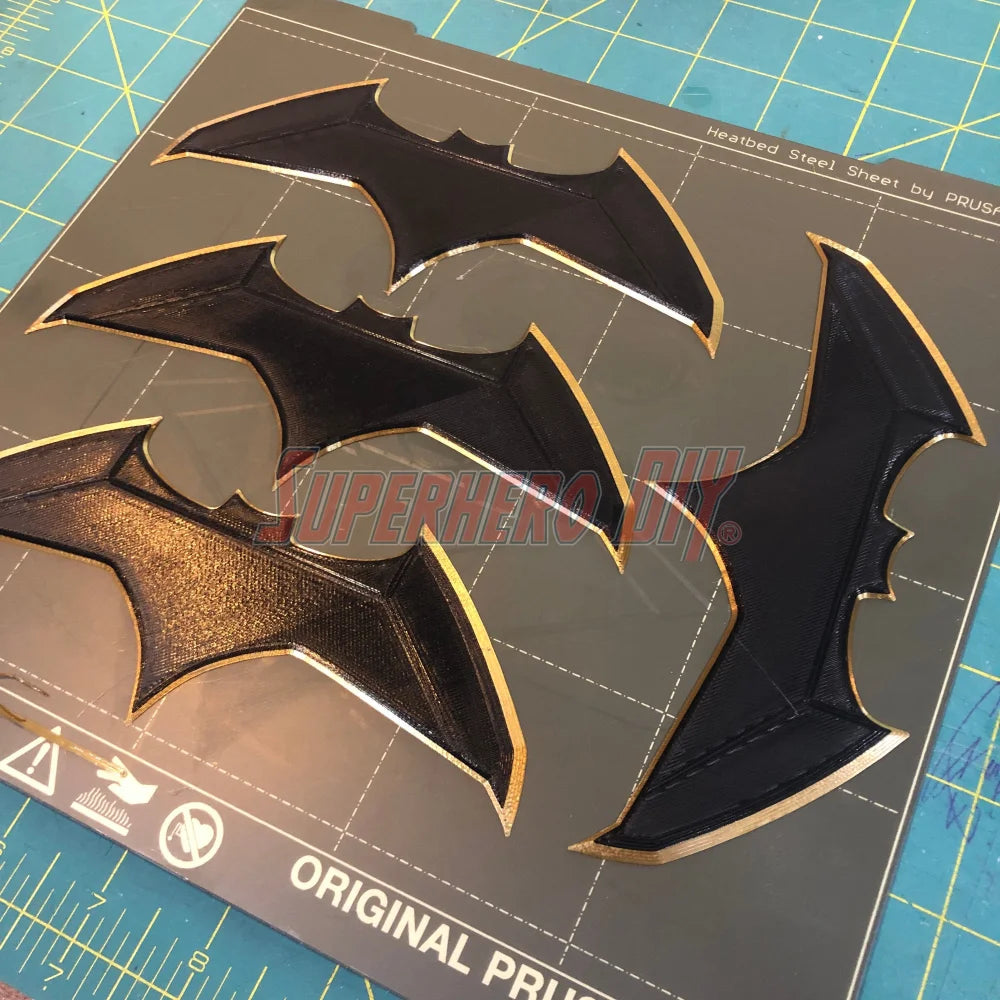 BvS JL batarang prop 3D-printed in black and gold PLA plastic for cosplay and costumes