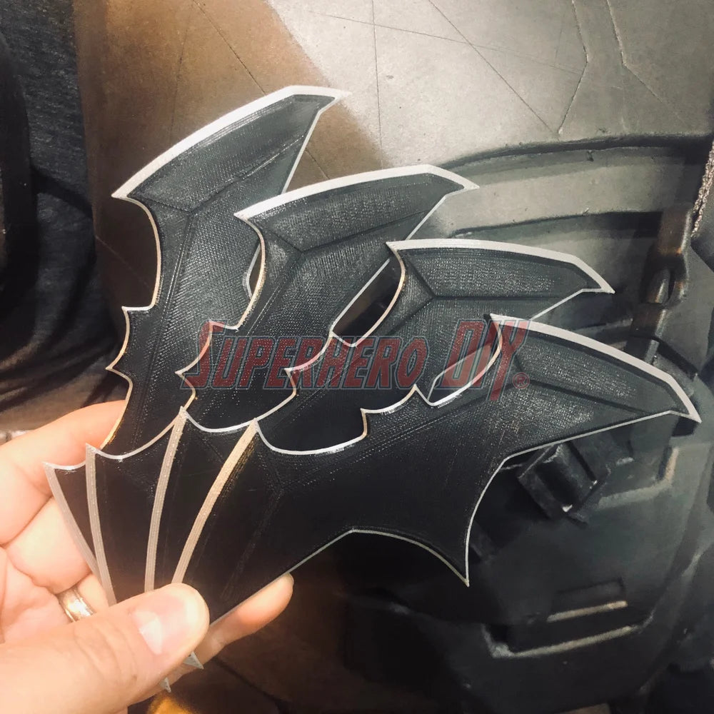 Hand holding BvS JL batarang prop, 3D-printed in black plastic, perfect for cosplay or costume accessory.