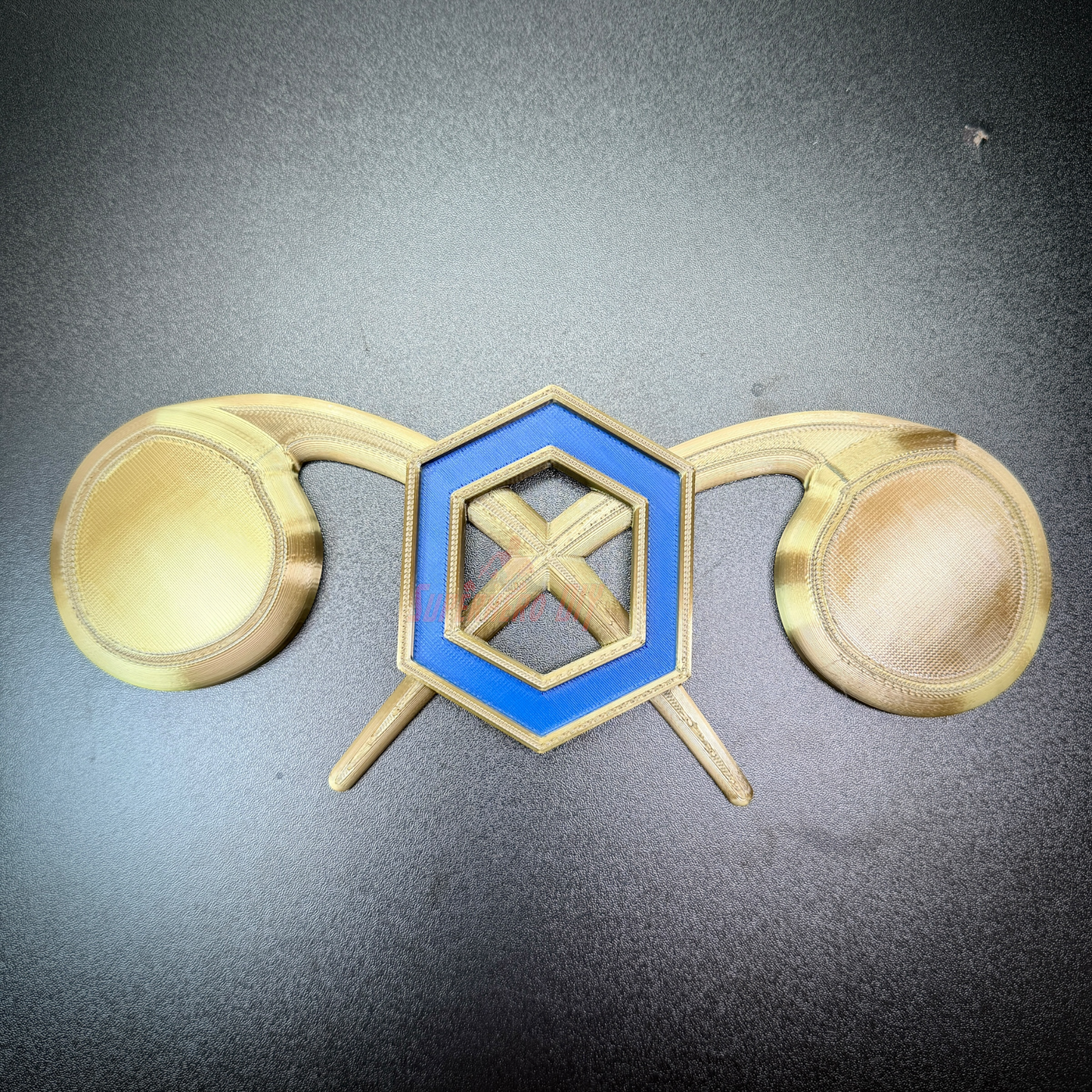 Chemical Corps insignia featuring a cobalt blue benzene ring and crossed gold retorts on a flat background.