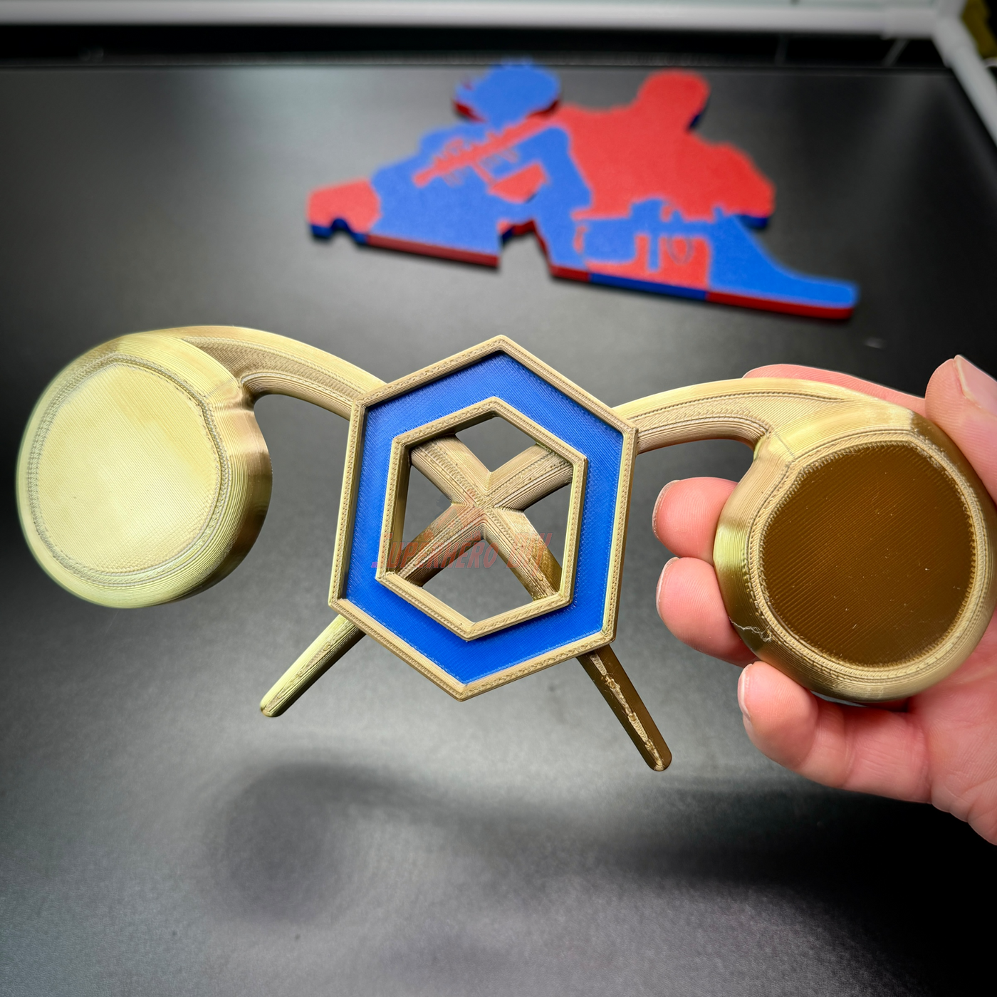 Chemical Corps insignia in hand, showcasing cobalt blue and gold design for wall display.