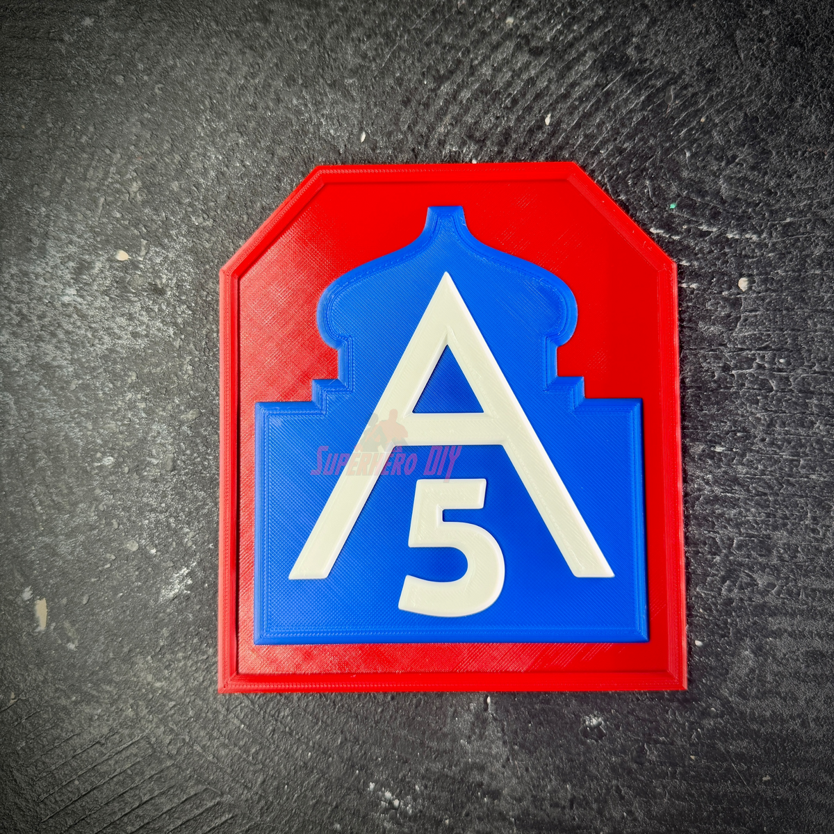 Fifth Army insignia wall display, red field with blue mosque and white A and 5, laid flat on dark textured stone