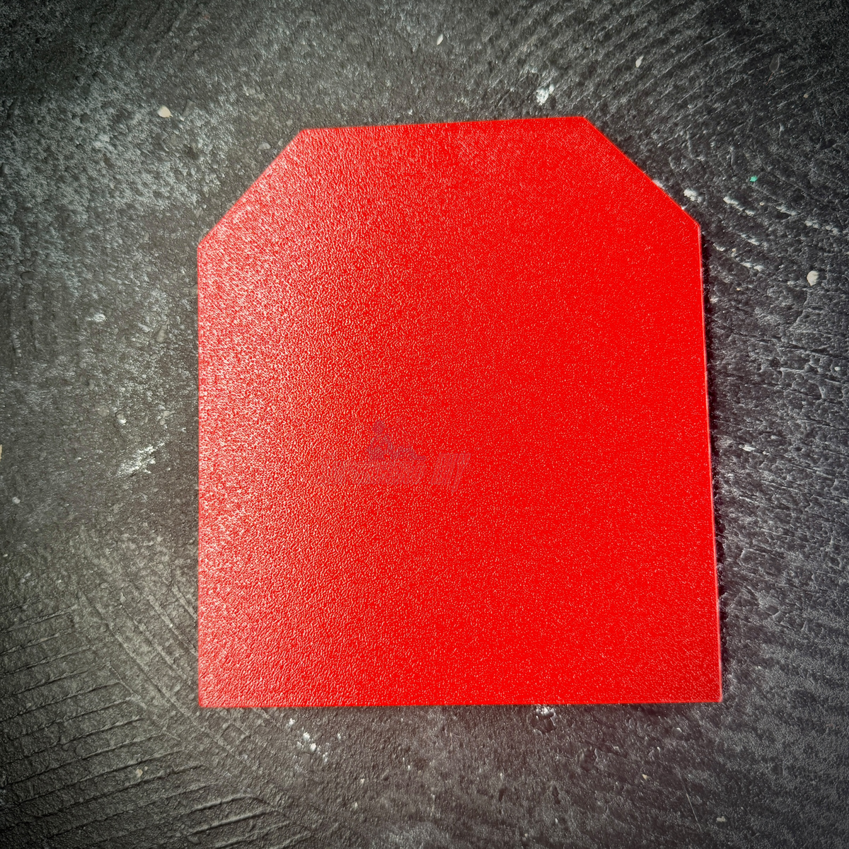 Smooth flat red back of the Fifth Army insignia display, ready for adhesive strips or mounting tape